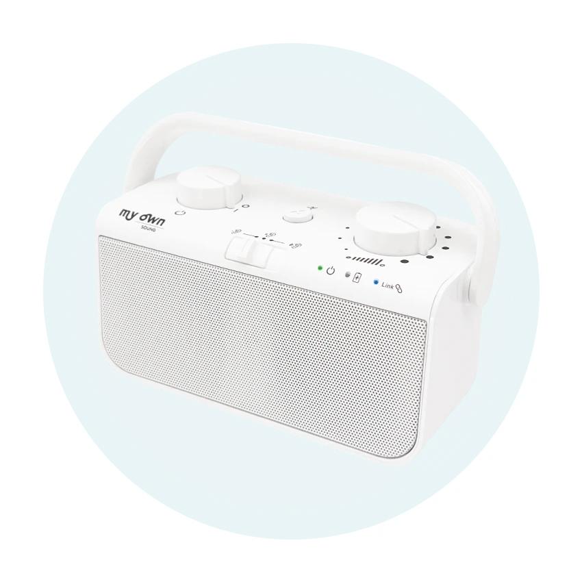 White portable Bluetooth speaker with handle.
